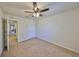 Neutral bedroom features carpeted floor and a ceiling fan with integrated lighting at 8306 Red Spruce Ave, Riverview, FL 33578