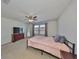 Comfortable bedroom with a ceiling fan, plush carpeting, and ample natural light at 8306 Red Spruce Ave, Riverview, FL 33578