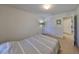 Well-lit bedroom with carpeted floors, a lamp, closet, and access to other rooms at 8306 Red Spruce Ave, Riverview, FL 33578