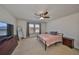Bright bedroom with a ceiling fan, neutral carpet, and natural light from the window at 8306 Red Spruce Ave, Riverview, FL 33578