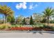 A charming community clubhouse is surrounded by lush landscaping and palm trees at 8306 Red Spruce Ave, Riverview, FL 33578