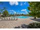 Resort-style community pool with plenty of chairs and umbrellas for lounging at 8306 Red Spruce Ave, Riverview, FL 33578