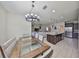 Open concept dining area with modern lighting fixture and view to the kitchen and living room at 8306 Red Spruce Ave, Riverview, FL 33578