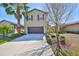 Inviting two-story home with a neatly landscaped front yard and attached two-car garage at 8306 Red Spruce Ave, Riverview, FL 33578