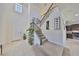 Bright foyer with high ceilings, tiled floors, and a staircase with decorative iron railings and carpeted steps at 8306 Red Spruce Ave, Riverview, FL 33578