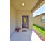 A welcoming front entryway showcases a door adorned with a decorative wreath and a red flower pot at 8306 Red Spruce Ave, Riverview, FL 33578