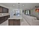 Gourmet kitchen with large island, stainless appliances, and an open layout to the living area at 8306 Red Spruce Ave, Riverview, FL 33578