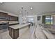Modern kitchen with stainless steel appliances, granite countertops, and spacious island at 8306 Red Spruce Ave, Riverview, FL 33578