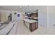 Open concept kitchen with granite countertops, stainless steel appliances, and a large island with seating at 8306 Red Spruce Ave, Riverview, FL 33578