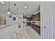 Kitchen featuring stainless steel appliances, dark wood cabinets, granite countertops, and a large island at 8306 Red Spruce Ave, Riverview, FL 33578