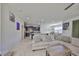 Bright living room with open floorplan adjacent to modern kitchen at 8306 Red Spruce Ave, Riverview, FL 33578