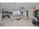Open-concept living room with tile floors seamlessly connecting to a modern kitchen at 8306 Red Spruce Ave, Riverview, FL 33578