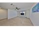 Bright and spacious carpeted loft area with a ceiling fan, providing a versatile living space at 8306 Red Spruce Ave, Riverview, FL 33578