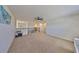 Open loft area featuring neutral carpeting, a ceiling fan, and ample space for various activities at 8306 Red Spruce Ave, Riverview, FL 33578