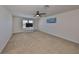 Large carpeted loft with a ceiling fan, a TV console, and plenty of open space for relaxing or entertaining at 8306 Red Spruce Ave, Riverview, FL 33578