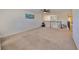 Spacious carpeted loft area with a ceiling fan, natural light, and views of the staircase at 8306 Red Spruce Ave, Riverview, FL 33578