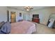 Comfortable main bedroom with carpet, dresser, TV, and walk-in closet access, offering a serene retreat at 8306 Red Spruce Ave, Riverview, FL 33578