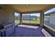 Covered and screened in patio overlooking a large green yard and pond with mature landscaping at 8306 Red Spruce Ave, Riverview, FL 33578