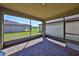 Covered and screened in patio overlooking a large green yard and pond, with a view of mature landscaping at 8306 Red Spruce Ave, Riverview, FL 33578