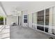 This screened-in back porch features ample space and view of the pool at 954 Cobblestone Ln, Tarpon Springs, FL 34688