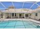 View of backyard with patio, pool, and view of the exterior of home at 954 Cobblestone Ln, Tarpon Springs, FL 34688