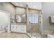 Well-lit bathroom featuring a glass-enclosed shower and a vanity with a framed mirror at 954 Cobblestone Ln, Tarpon Springs, FL 34688