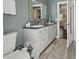 Bathroom boasts a double sink vanity with granite countertop, and stylish fixtures at 954 Cobblestone Ln, Tarpon Springs, FL 34688