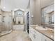 Bright Primary bath with walk-in shower, soaking tub, and a vanity with granite countertop at 954 Cobblestone Ln, Tarpon Springs, FL 34688