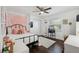 Comfortable bedroom offers a metal frame bed, crown molding, a window and a decorative shelving unit at 954 Cobblestone Ln, Tarpon Springs, FL 34688