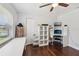 Bright bedroom featuring wood floors, ceiling fan, and desk at 954 Cobblestone Ln, Tarpon Springs, FL 34688