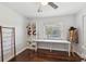 Bright bedroom with hardwood floors, ceiling fan, and large window views at 954 Cobblestone Ln, Tarpon Springs, FL 34688
