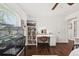 Bedroom features hardwood floors, crown molding, a lit vanity and shelving units at 954 Cobblestone Ln, Tarpon Springs, FL 34688