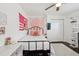 Charming bedroom features a metal frame bed, crown molding, and stylish decor at 954 Cobblestone Ln, Tarpon Springs, FL 34688