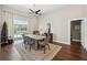 Dining room showcasing hardwood floors and sliding glass doors to the pool area at 954 Cobblestone Ln, Tarpon Springs, FL 34688