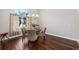 Cozy dining area with a chandelier, natural light, and hardwood floors at 954 Cobblestone Ln, Tarpon Springs, FL 34688