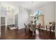 Inviting dining area next to the entrance with hardwood floors and natural lighting at 954 Cobblestone Ln, Tarpon Springs, FL 34688