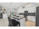 Beautiful kitchen featuring custom cabinets, granite countertops, an island, and modern appliances at 954 Cobblestone Ln, Tarpon Springs, FL 34688