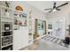 Kitchen with built-in storage and French doors leading to the pool and outdoor living space at 954 Cobblestone Ln, Tarpon Springs, FL 34688