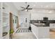 Kitchen with white cabinets, stainless appliances and French doors leading to the pool and backyard at 954 Cobblestone Ln, Tarpon Springs, FL 34688