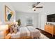 Comfortable main bedroom featuring soft colors, tray ceiling, and hardwood floors at 954 Cobblestone Ln, Tarpon Springs, FL 34688