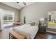 Bright main bedroom with hardwood floors, a desk area, and a pool view at 954 Cobblestone Ln, Tarpon Springs, FL 34688