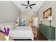 Comfortable bedroom featuring hardwood floors, a ceiling fan, and an ensuite bathroom at 954 Cobblestone Ln, Tarpon Springs, FL 34688