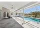 Enjoy this screened-in patio and swimming pool overlooking the tranquil pond at 954 Cobblestone Ln, Tarpon Springs, FL 34688