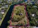 Expansive waterfront property featuring mature trees and a private home, bordered by a waterway offering serene views at 9554 90Th Ave, Seminole, FL 33777