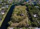 Expansive waterfront property featuring mature trees and a private home, bordered by a waterway offering serene views at 9554 90Th Ave, Seminole, FL 33777