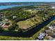 Stunning aerial view of an expansive property featuring lush greenery and a serene river at 9554 90Th Ave, Seminole, FL 33777