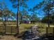 Private property features large grassy area, bordered by mature trees, enhancing the home's appeal and offering seclusion at 9554 90Th Ave, Seminole, FL 33777