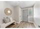 Modern entryway with wood-look flooring, a decorative mirror, and a comfortable bench seating at 971 Mcfarland St, Dunedin, FL 34698