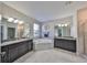 Elegant bathroom featuring dual sinks, granite countertops, and a soaking tub at 10072 Sage Creek Dr, Ruskin, FL 33573