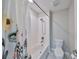 Cozy bathroom featuring a shower-tub combo and a white toilet at 10072 Sage Creek Dr, Ruskin, FL 33573